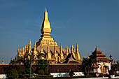 Vientiane, Laos - Surrounded by a cluster of pointed minor stupas the huge Pha That Luang shined under the warm light of the sunset. 